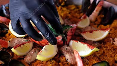 Slow motion video close up view of paella traditional spanish cuisine in big shallow pan