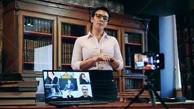 A woman is teaching an internet class in the library