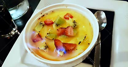 Catalan cream with fruit and flame on