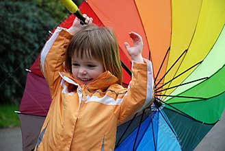 Toddler girl with colorful umbrella