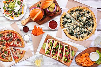 Healthy plant based fast food table scene. Above view on a white wood background.