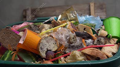 Organic waste, unsold food, uneaten bread, plastic in the trash can. The food throw out in household, home kitchen or in