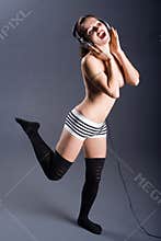Topless woman with headphones