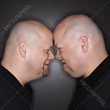 Twin men facing off.
