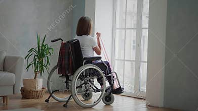 Disabled woman is exercising at home