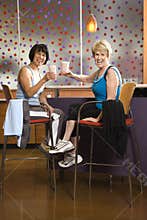 Women sitting with drinks.