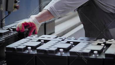 Factory for the production of batteries. Car batteries are collected semi-automatically.