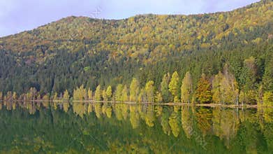 Drone flying above autumn mountain lake, St. Ana Lake