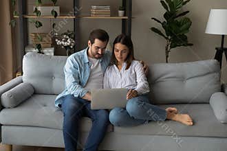 Serious young couple holding laptop consider on wedding planning