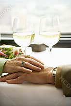 Couple touching hands.
