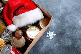 Christmas donation, charity, food bank, help for low income, poor families, homeless people. Cardboard box full of