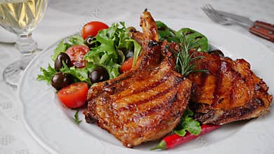 Lamb pork chops grilled with salad on plate rotate. Loin on ribs