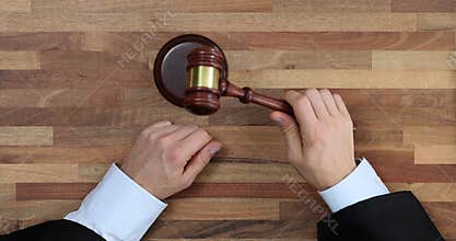 Man judge bangs gavel after sentencing in courtroom