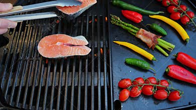 Put the salmon steak on the grill. Grilled vegetables with steak fish