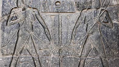 Ancient Egyptian hieroglyphs and bas-reliefs close-up in Luxor Temple, ancient Thebes, Egypt. Luxor Temple is a large