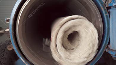 Wet carpet in the automatic centrifuge for washing