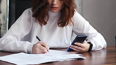 Writing, phone and papers with hands of caucasian woman in home office for research, planning or information. Document