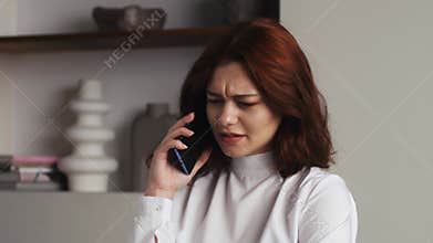 Closeup business woman talking friendly on cell phone at home or office. Portrait of pretty woman flirting on phone