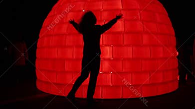 Silhouette of woman posing on red illuminated