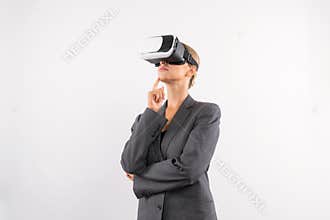 Smart businesswoman thinking about plan while wearing VR glasses. Contraption.