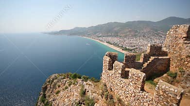 Cliff in sea, fragment of fortress wall, sea and