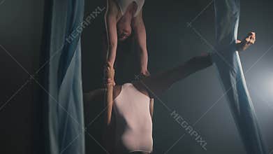 Two aerial gymnasts show tricks