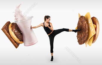 Fit young woman fighting off fast food