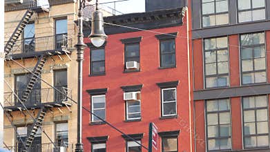 New York City building architecture, Manhattan. Residential house exterior. Red brick, fire escape.