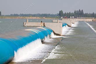 Rubber dam and flowing water on a river