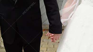 Closeup view of married couple holding hands