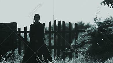 Horror scene of a scary woman in black dress walking towards the camera