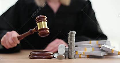 Judge bangs gavel until pennies stacked in tall towers scatter