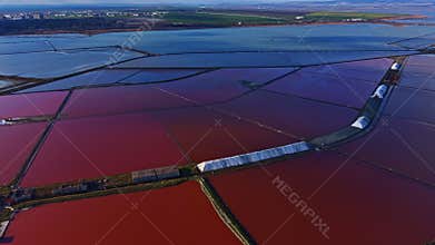 Colorful salt pans shimmer under the sun in a vibrant landscape showcasing nature s artistry at work