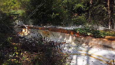 Flowing lime from a pipe and acid mine drainage reaction, water treatment
