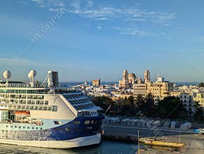 Cadiz, Spain 2025.09.13. - Cruise ship docked in Cadiz in the morning with the Cathedral in the background