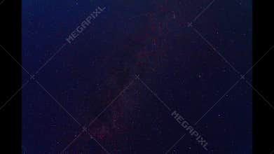 Horizontal time lapse video of night sky, segment of Milky Way Galaxy rotates clockwise. Time-lapse footage for study of