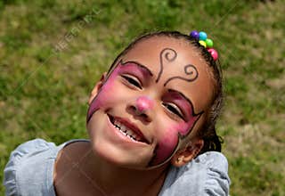 Young Girl Wearing Face Paint and Smiling Brightly