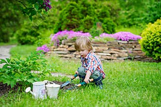 Kid planting flowers in the garden
