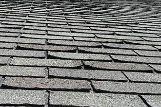 Old Bad and Curling Roof Shingles on a House or Home