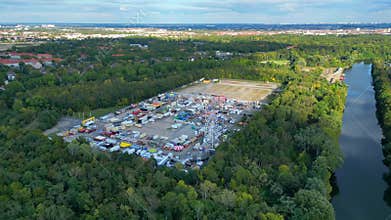 Berlin funfair with carnival rides and stalls Dramatic aerial view flight drone