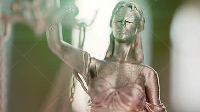 Slow Upward Handheld Crane Movement of Lady Justice Statue In An Office Setting