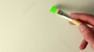 Hand painting green with paintbrush
