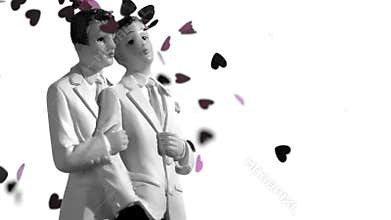 Confetti falling on gay groom cake toppers in black and white