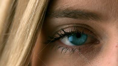 Pretty blonde opening her eye close up