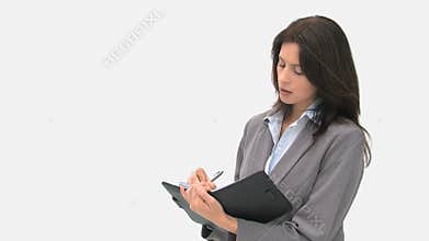 Businesswoman writing on her agenda