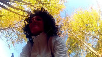 Woman Throwing autumn leaves