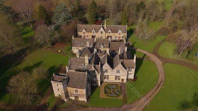 Aerial view of old manor house, stately home with Victorian era architecture and large green landscape