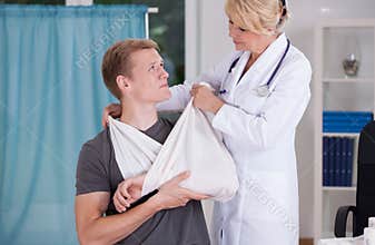 Physician binding a sling