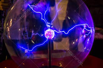 Plasma ball with smooth magenta-blue flames on a dark background.