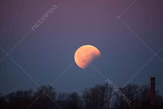 Big moon rising partial eclipse of moon after full eclipse of moon.